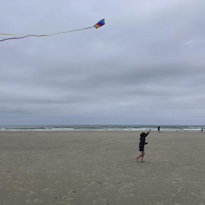 Child flying a kite on beach